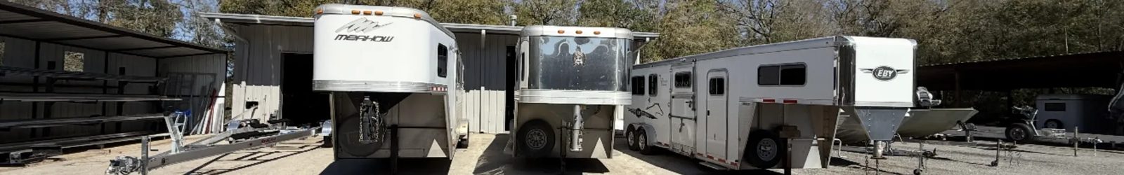 Merhow and EBY aluminum gooseneck horse trailers lined up outside the RedLine Custom Trailers shop in Ocala, Florida