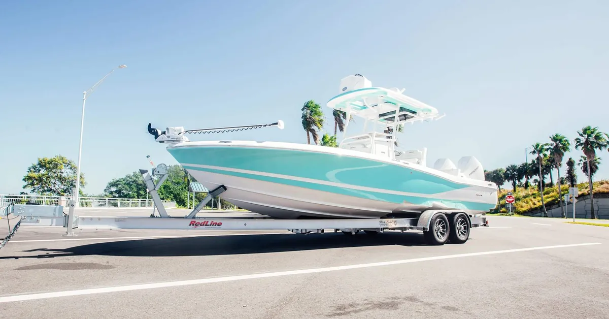 RedLine tandem-axle aluminum boat trailer under a bay boat in Ocala, Florida